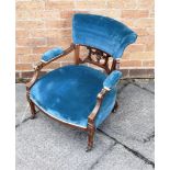 AN EDWARDIAN CARVE D WALNUT FRAMED NURSING CHAIR on tapering supports with spade feet