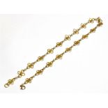 A VINTAGE 9CT GOLD AND CULTURED-PEARL QUATREFOIL NECKLACE in the form of 20 open flower-head