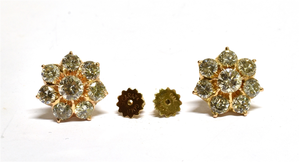 A PAIR OF DIAMOND FLOWER-HEAD CLUSTER STUD EARRINGS each claw set at the centre with a round - Image 2 of 4