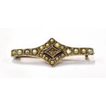 AN EDWARDIAN GOLD, ROSE-DIAMOND, HALF-PEARL AND BLUE ENAMEL SHAPED BAR BROOCH centred with a small