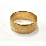 A 9CT GOLD BROAD BAND RING the 9mm wide band of shallow 'D' section, Birmingham 1956, size W, 8g