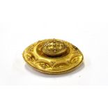 A MID VICTORIAN GOLD OVAL LOCKET-BACK BROOCH the central oval bosse decorated with wirework and