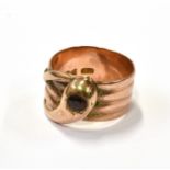 AN EARLY 20TH CENTURY 9CT ROSE GOLD AND SMALL GARNET 'SNAKE' RING in the form of a coiled snake with