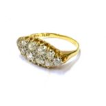 AN EARLY 20TH CENTURY GOLD AND DIAMOND OVAL CLUSTER RING designed to run across the finger, the ten