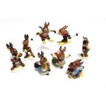 EIGHT GOEBEL RABBIT FIGURINES comprising two skiers, a tobogganist, an ice-skater, a golfer, two