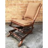 A VICTORIAN UPHOLSTERED ROCKING CHAIR