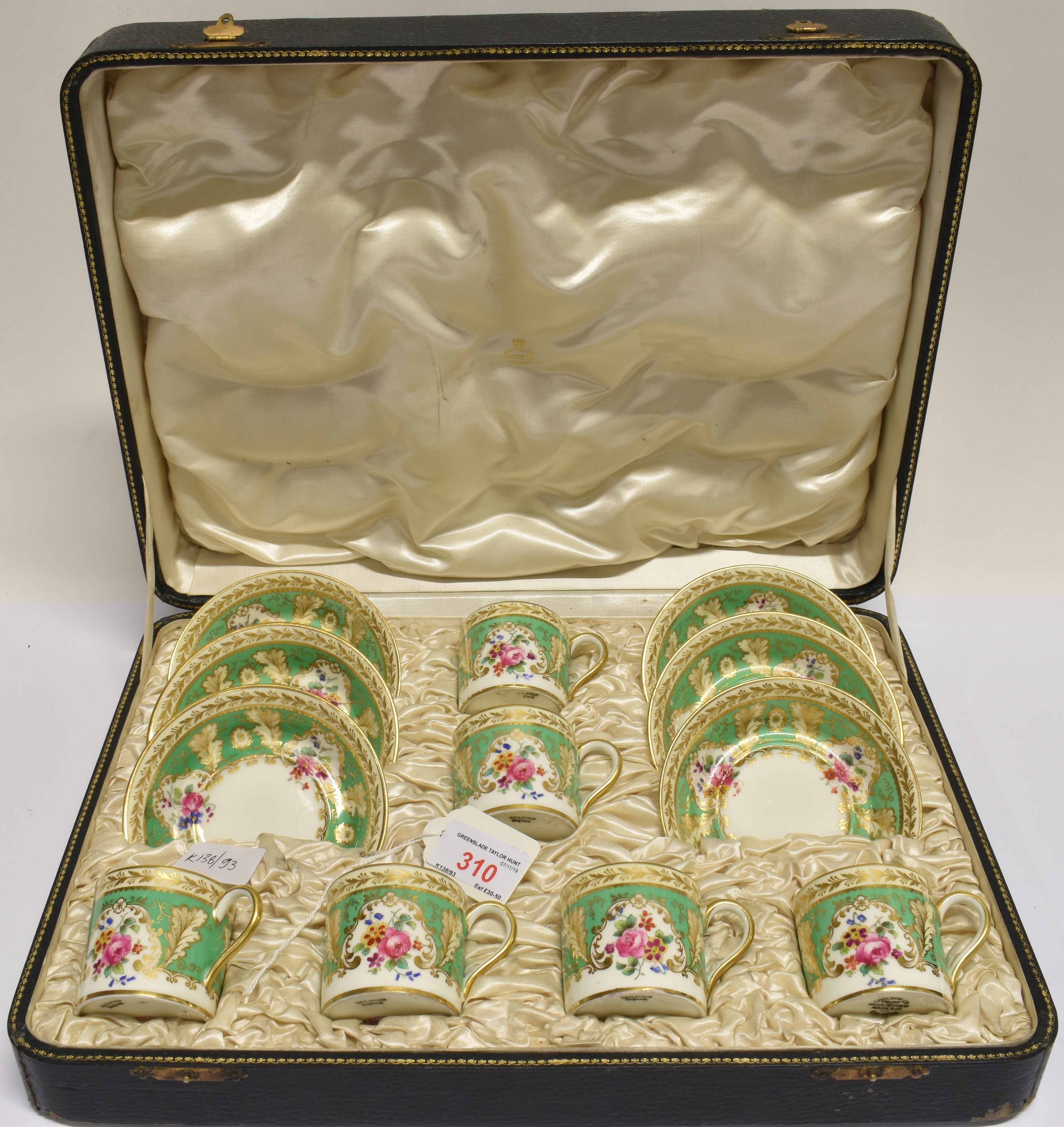 A CASED SET OF SIX CAULDON COFFEE CANS AND SAUCERS with floral and gilt decoration, retailed by