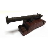 MILITARIA - A MINIATURE TABLE CANNON the cast bronze barrel 24.75cm long overall, set to a stained