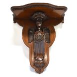 A CARVED MAHOGANY WALL BRACKET with gryphon support, 38cm wide 42cm high