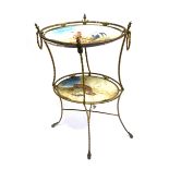 A CONTINENTAL TWO TIER GILT METAL FRAMED ETAGERE the two oval trays with enamelled decoration of