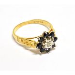 AN 18CT GOLD, SAPPHIRE AND DIAMOND FLOWER-HEAD CLUSTER RING centred with a small eight-cut diamond