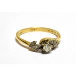 AN 18CT GOLD AND DIAMOND SINGLE STONE CROSS-OVER RING the round brilliant approx. 0.18cts, claw