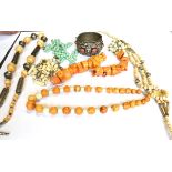 THREE NORTH AFRICAN BONE AND BEAD NECKLACES, A STAINED CORAL UNSTRUNG NECKLACE AND OTHER ITEMS