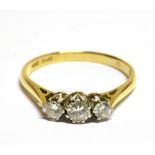 AN EARLY/MID-20TH CENTURY GOLD AND DIAMOND THREE STONE RING the graduated round brilliants approx.