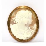 A LATE VICTORIAN GOLD AND OVAL SHELL CAMEO BROOCH depicting Diana and Apollo amidst clouds, rub-over