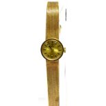 TISSOT, A LADY'S 9CT GOLD ROUND BRACELET WATCH, CIRCA 1974 brushed golden dial with raised black