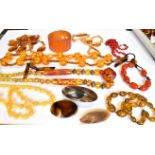 A MID-20TH CENTURY PLASTIC IMITATION-AMBER BROAD BANGLE AND OTHER ITEMS including six imitation-