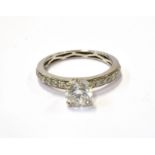 A DIAMOND SOLITAIRE RING WITH DIAMOND SHOULDERS the round brilliant approx. 1.00cts, in a white