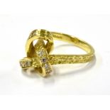 A 1970'S 18CT GOLD AND DIAMOND ABSTRACT KNOT RING in the form of an inter-woven textured square-