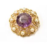 A MODERN AMETHYST AND CULTURED-HALF-PEARL BROOCH centred with a round mixed-cut amethyst within an