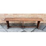 A FRUITWOOD HALL BENCH the three shaped supports united by stretcher, 184cm long