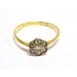 AN ART DECO DIAMOND SEVEN STONE FLOWER-HEAD CLUSTER RING the eight-cut stones grain and rub-over set