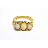 A VINTAGE 18CT GOLD AND OPAL THREE STONE CARVED HALF-HOOP RING the three graduated oval cabochon