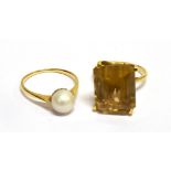 A MODERN RECTANGULAR CITRINE SINGLE STONE RING AND A CULTURED-PEARL SINGLE STONE RING the step-cut