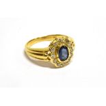 A VINTAGE CONTINENTAL 18CT GOLD, SAPPHIRE AND DIAMOND OVAL CLUSTER RING centred with an oval mixed-