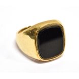 A VINTAGE 9CT GOLD AND BLACK-ONYX OBLONG SIGNET RING the stone rub-over set to a tapering shank,