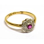 AN ART DECO RUBY AND DIAMOND FLOWER-HEAD CLUSTER RING the central round mixed-cut ruby rub-over