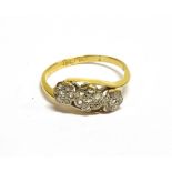 AN EARLY 20TH CENTURY ROSE DIAMOND TRIPLE CLUSTER CROSS-OVER RING the seven stone cluster rub-over