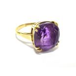 A VINTAGE GOLD AND CUSHION-SHAPED AMETHYST SINGLE STONE RING the dark-violet amethyst, in a simple