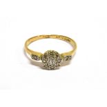 AN ART DECO GOLD AND DIAMOND CLUSTER RING with diamond single stone shoulders, the 11 eight-cut