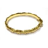 A VINTAGE 9CT GOLD 'BAMBOO' HINGED BANGLE Naturalistically shaped and lightly-textured, Birmingham