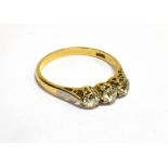 A MID 20TH CENTURY GOLD AND DIAMOND THREE STONE RING the old-cut stones approx. 0.98cts total,