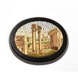 A VICTORIAN OVAL MICRO MOSAIC PANEL DEPICTING THE TEMPLE OF VESPASIAN AND THE FORUM, ROME on a black