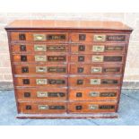 A VICTORIAN LARGE MULTI-DRAWER DRAPER'S CHEST of stained pine construction, the fourteen brass-