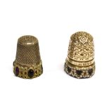 TWO THIMBLES comprising a silver thimble, by Charles Horner, with a floral decorated domed crown and