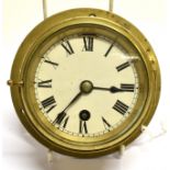 A SECOND WORLD WAR BRASS BULK HEAD CLOCK, BY F.W. ELLIOTT LIMITED, CROYDON the circular white dial