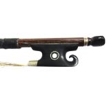 A VIOLIN BOW stamped 'Pecatte', the ebony frog with a scroll end and a mother of pearl eye, 74cm