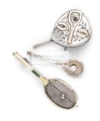 A Victorian fan shaped brooch in silver, with gold tennis racquet and horseshoe relief,