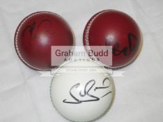 A group of six leather cricket balls & a group of eight mini-bats signed by current England players.
