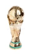 A full size replica of the FIFA World Cup Trophy, the gilt earth held in the air by two maidens,