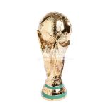 A full size replica of the FIFA World Cup Trophy, the gilt earth held in the air by two maidens,