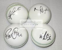 A group of four white leather cricket balls signed by the Australian players Glenn Maxwell,