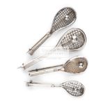 Four Victorian silver tilt head tennis racquet brooches, each with a tennis ball on the stringing,