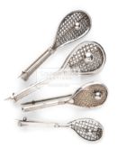 Four Victorian silver tilt head tennis racquet brooches, each with a tennis ball on the stringing,