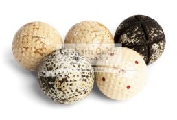 A group of five golf balls,