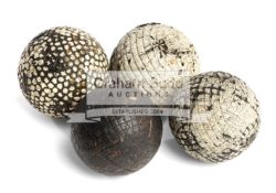 A group of three moulded gutta percha golf balls,